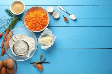Different ingredients for making carrot cake on light blue wooden table, flat lay. Space for text