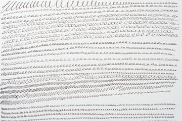 set of cursive or repeating looping lines on textured paper