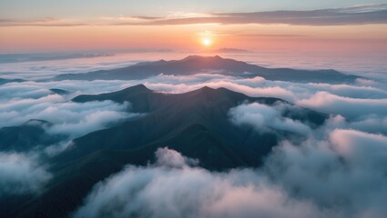 Obraz premium Captivating Sunrise Over Mountain Peaks Surrounded By Misty Clouds In A Tranquil Aerial Landscape Perfect For Nature Photography.