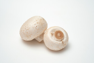 Whole champignons mushrooms on white background