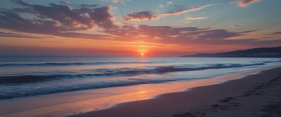 Fototapeta premium Serene Coastal Sunset Over Tranquil Waves with Colorful Sky Reflections on Sandy Beach