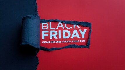 Torn paper reveals a Black Friday announcement on red background
