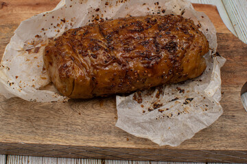 Seitan: vegan meat alternative made of washed flour gluten spices. Roasted and served on wooden board