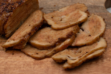 Seitan: vegan meat alternative made of washed flour gluten spices. Roasted and served on wooden board