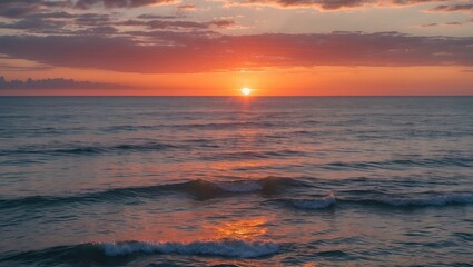 Sunset over calm ocean waters with waves and colorful sky clouds reflecting sunlight Copy Space