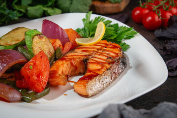 Grilled Salmon Steak with Roasted Vegetables and Lemon