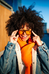 Stylish woman with afro hair enjoying urban vibes