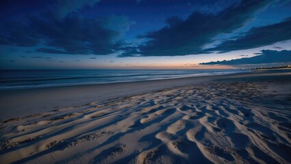 Serene beach landscape at twilight with soft waves, textured sand patterns, and dramatic cloud formations, Copy Space available
