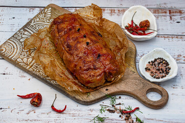 Seitan roast flavored with spices, glazed and served on wooden board