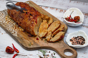 Seitan roast flavored with spices, glazed and served on wooden board