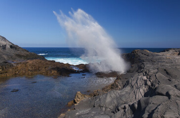 Fototapeta premium Gran Canaria, salt evaporation ponds Salinas el Bufadero around a blowhole Bufadero in the coast of Arucas municipality