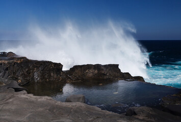 Gran Canaria, salt evaporation ponds Salinas el Bufadero around a blowhole Bufadero in the coast of Arucas municipality