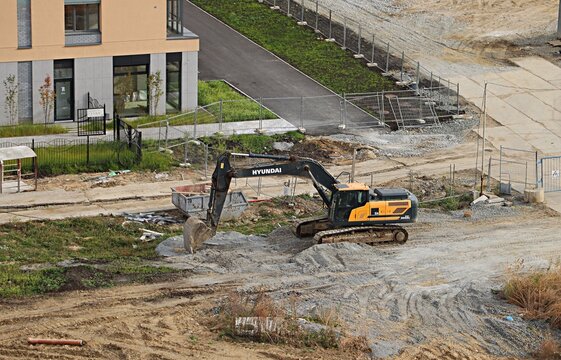 An excavator is carrying out work on planning a plot of land for construction