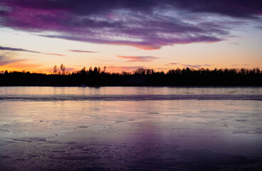 Fototapeta premium Scenic view of a lake at winter during evening