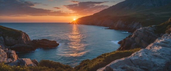Coastal sunset view over calm waters with rocky shore and green vegetation in foreground under cloudy sky Copy Space