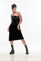 Young beautiful girl brunette of an eastern outbreak of black dress on a white background