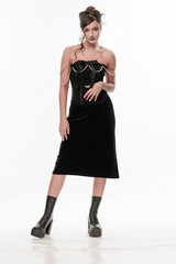 Young beautiful girl brunette of an eastern outbreak of black dress on a white background