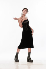 Young beautiful girl brunette of an eastern outbreak of black dress on a white background