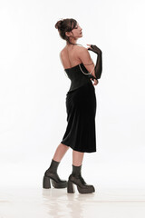 Young beautiful girl brunette of an eastern outbreak of black dress on a white background