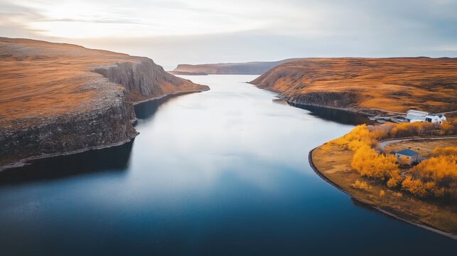 A breathtaking aerial view captures a winding river glistening under soft light, bordered by vibrant autumn foliage and stark cliffs, evoking inspiration and tranquility for business presentations