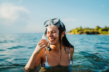 Young caucasian woman with scuba diving mask swim in the sea	
