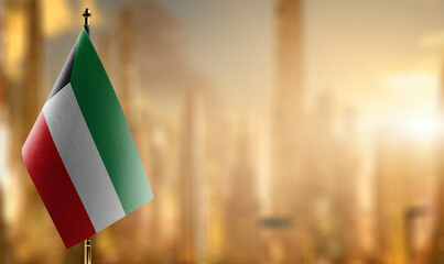 Small flags of the Kuwait on an abstract blurry background