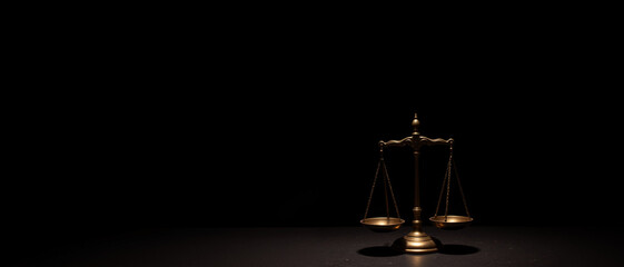 A vintage brass scale illuminated dramatically against a black background conveys a serious and contemplative tone representing justice and balance in financial matters