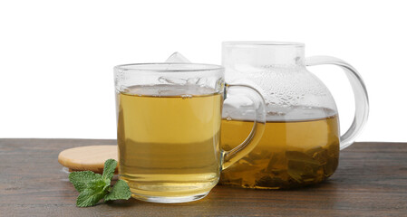 Aromatic mint tea and fresh leaves on wooden table against white background