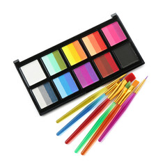 Bright face paint palette and brushes isolated on white, top view