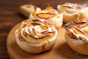 Freshly baked apple roses on table, closeup