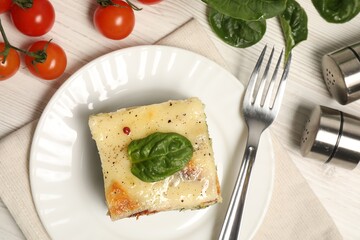 Delicious spinach lasagne served on white wooden table, flat lay