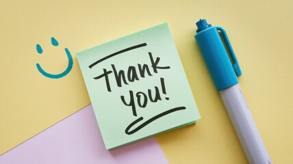 Green sticky note showing thank you on a colorful background