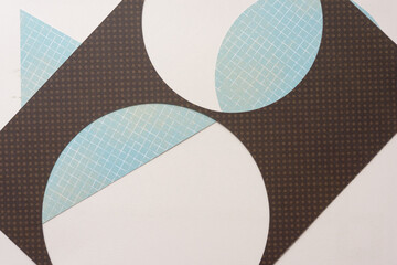 machine-cut stencil with circle frames on geometric shapes and blank paper