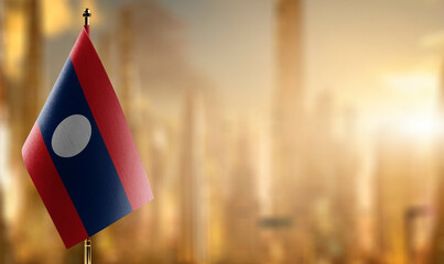 Small flags of the Laos on an abstract blurry background