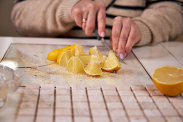 the process of preparing a natural cleaning product with lemons for cleaning the house, still life top view