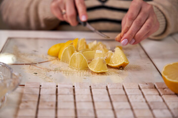 the process of preparing a natural cleaning product with lemons for cleaning the house, still life top view