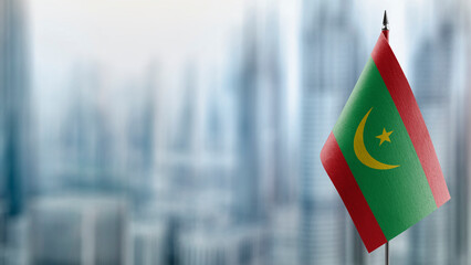 Small flags of the Mauritania on an abstract blurry background