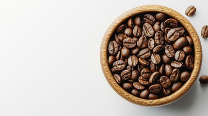 Fototapeta premium A wooden bowl is filled to the brim with dark brown coffee beans, creating a warm and inviting image on a white background.