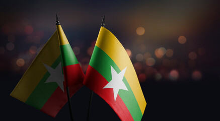 Small flags of the Myanmar on an abstract blurry background