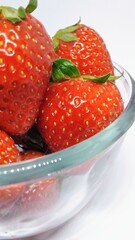Red fresh strawberry in a bowl isolated on white background