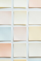 Fototapeta premium Symmetrical arrangement of blank sticky notes in soft pastel colors inviting creativity and organization