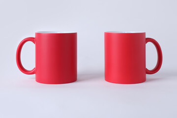 Two blank red mugs on white background. Mockup for design