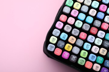 Many colorful markers in bag on pink background, top view