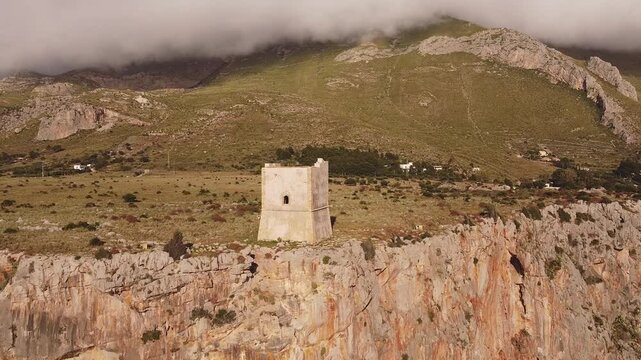 Aerial drone view of Macari (Makari), Sicily. Crystal clear turquoise waters, rugged cliffs, golden sandy beaches. A serene natural landscape with Mediterranean charm near San Vito lo Capo.	
