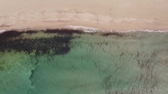 Aerial drone view of Macari (Makari), Sicily. Crystal clear turquoise waters, rugged cliffs, golden sandy beaches. A serene natural landscape with Mediterranean charm near San Vito lo Capo.	