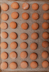 A batch of baked cookies on a baking sheet.