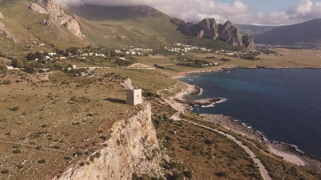 Aerial drone view of Macari (Makari), Sicily. Crystal clear turquoise waters, rugged cliffs, golden sandy beaches. A serene natural landscape with Mediterranean charm near San Vito lo Capo.	