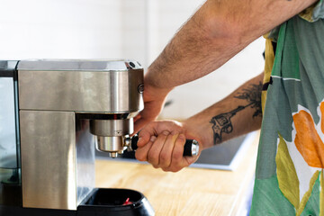 A man is making his first coffee of the day
