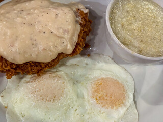 Eggs Over Easy, Chicken Fried Chicken With Gravy, And Grits For Breakfast