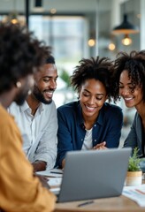 Young african american businesspeople working together using laptop in modern office